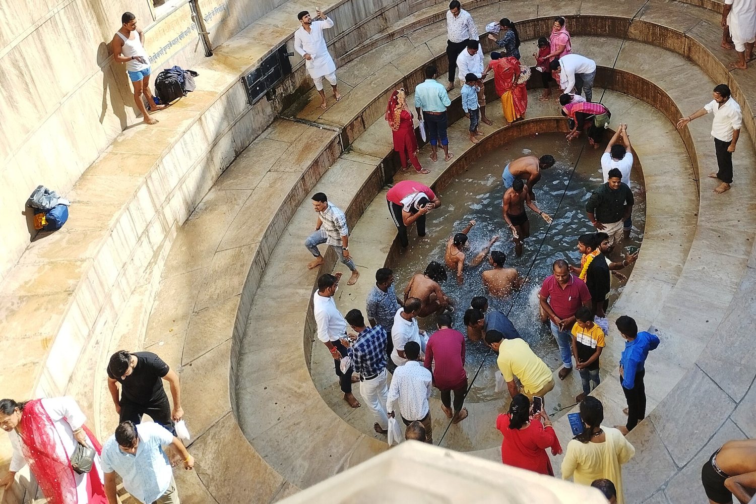 Pilgrims bathing in the stepped tank of Shyam Kund, Khatu